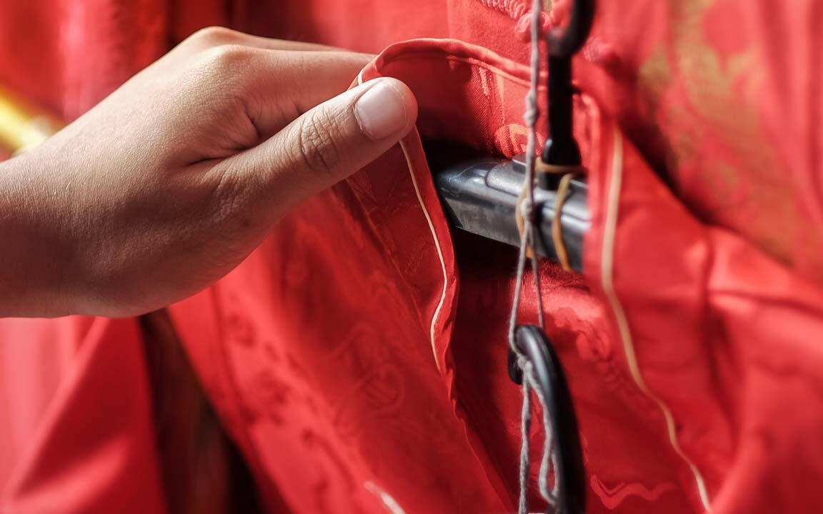 Red silk garments on hangers